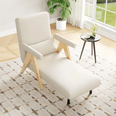 A cream-colored chaise lounge chair is placed on a patterned rug in a well-lit room with a large window.