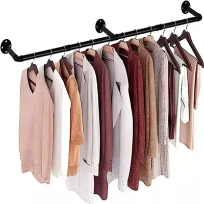 A black metal garment rack mounted on a white wall, displaying several hanging clothes.
