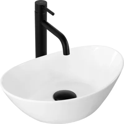 A white oval vessel sink with a black faucet and drain.
