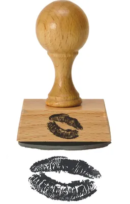 A wooden stamp with a lipstick kiss imprint on its base, shown above a separate imprint of the lipstick kiss.