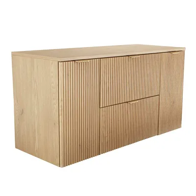 A light wood cabinet with fluted fronts and metal handles.