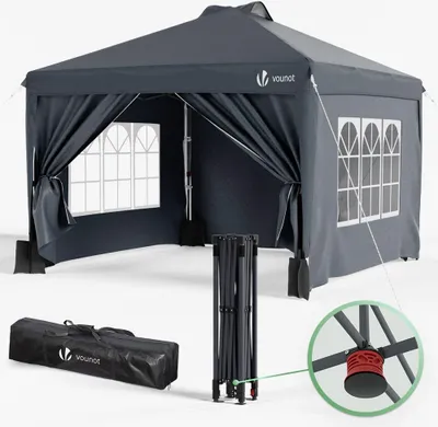A dark gray pop-up canopy tent is shown from the front, with its sides partially open. A folded frame and a carrying bag are displayed in the foreground. A close-up inset shows a red connector piece on the tent frame.