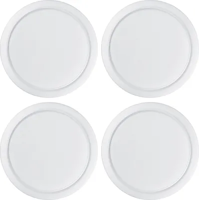 Four white circular cutting boards are arranged in a two-by-two grid on a white background.