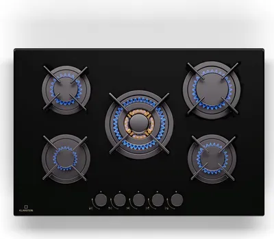 A top-down view of a black gas stovetop with five burners, some of which are lit with blue flames.