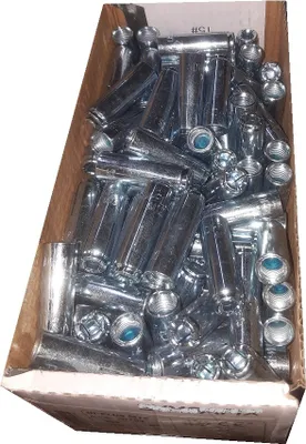 A cardboard box filled with metal fasteners.