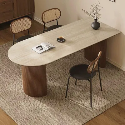 A dining table with chairs in a room setting.