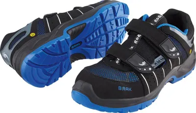 A pair of black and blue work shoes with velcro straps.