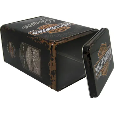 A close-up, angled view of a vintage-style Harley-Davidson tin box with its lid partially open, set against a white background.