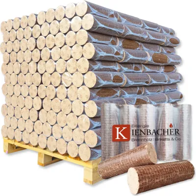 A large stack of wood briquettes on a pallet, with some loose briquettes in the foreground and a branded label.