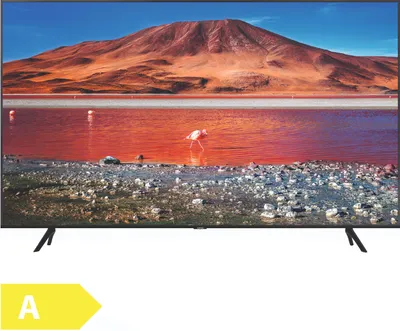 A television displaying a landscape image with a flamingo in the foreground, set on a stand.