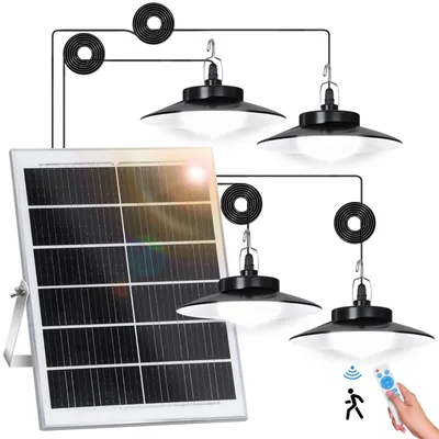 A solar panel connected to three hanging lights, with a remote control visible.