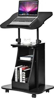 A black adjustable height desk with a laptop on top and books on the shelf.