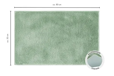A rectangular bath mat is shown from a top-down perspective, with dimensions indicated.