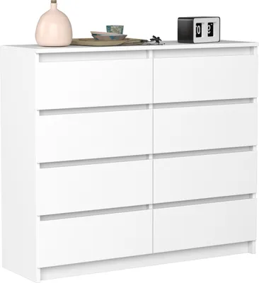 A white dresser with eight drawers is shown against a white background. Decorative items are placed on top of the dresser.