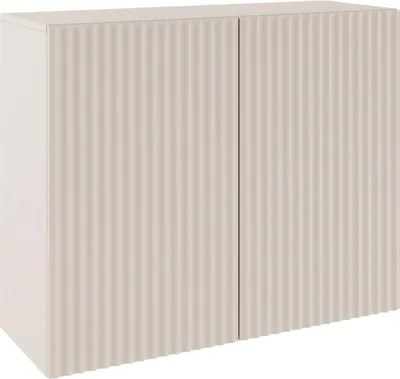 A studio shot of a two-door sideboard with ribbed fronts.