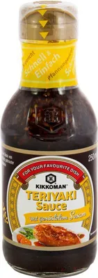 A bottle of Kikkoman Teriyaki Sauce with roasted sesame seeds.