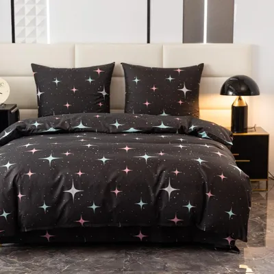 A bed with bedding featuring a star pattern.