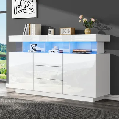 A modern white sideboard with blue LED lighting, displayed in a room setting with a window and artwork on the wall.