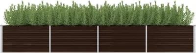 A raised garden bed filled with green plants.