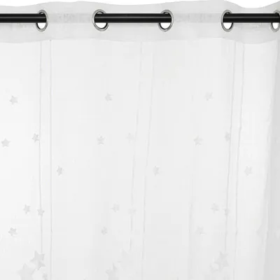 A close-up of a white curtain with small star patterns, hanging from a black curtain rod with grommets.