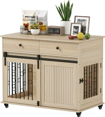 A dog crate furniture piece with decorative items on top.