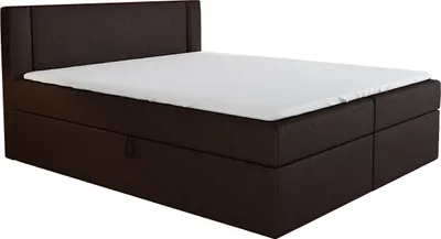 A dark brown boxspring bed with a white mattress and a headboard, shown from a side angle against a white background.