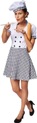 A woman dressed as a chef holding a baguette and tasting something from a spoon.