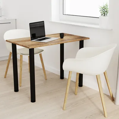 A small dining table with two chairs in a bright, modern room setting, next to a window.