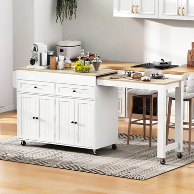 A kitchen island with an extended countertop and stools in a kitchen setting.