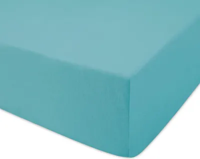 A close-up, angled view of a turquoise fitted sheet.