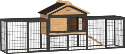 A product shot of a multi-level rabbit hutch with attached outdoor runs.
