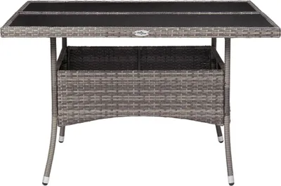 A grey poly rattan and glass dining table with a storage compartment underneath.