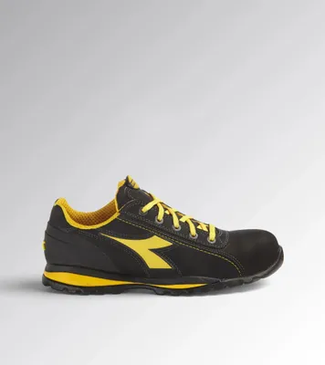 A black and yellow Diadora shoe is shown against a light gray and white background.