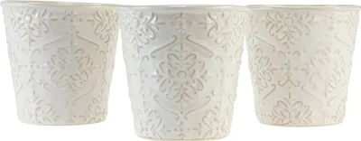 Three white ceramic pots with embossed floral patterns are displayed side-by-side against a white background.