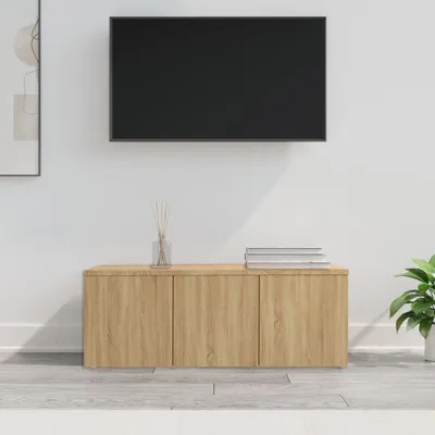 A wooden TV stand with a black TV mounted above it, against a white wall.