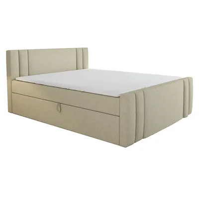 A beige boxspring bed with a mattress and a pull-out drawer.