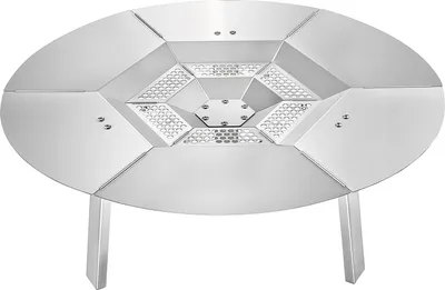 A silver, oval-shaped heat diffuser for a fire pit, with a geometric pattern in the center and three legs.