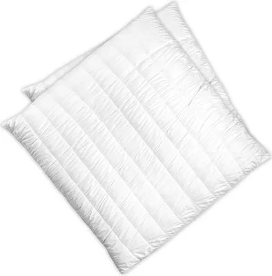 Two white quilted pillows are shown diagonally on a white background.