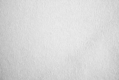 A close-up, top-down view of a white, textured fabric.