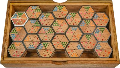 A wooden box filled with hexagonal domino tiles, each divided into smaller triangles with colored dots.