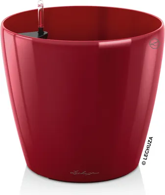 A red planter pot with a self-watering system.