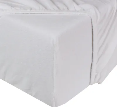 A close-up view of a white fitted sheet on a mattress.
