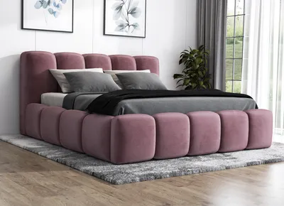 A modern bedroom setting with a pink upholstered bed, grey bedding, and two framed pictures on the wall.