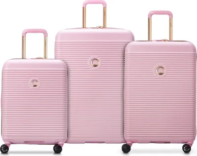 Three pink suitcases of different sizes are arranged side-by-side on a white background.