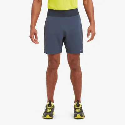 Mann trägt die "MEN"S SLIPSTREAM 7" SHORTS" von Montane in dunkelgrau; kombiniert mit einem hellen Oberteil und Sport-Schuhen.
