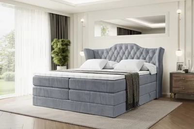 A bedroom scene with a large bed as the main focus.