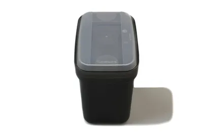 A black Tupperware container with a translucent gray lid is shown against a white background.