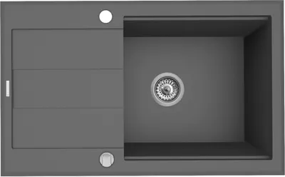 A top-down view of a gray kitchen sink with a drain and a ribbed draining board.