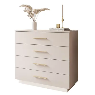 A beige chest of drawers with gold handles, decorated with a vase of dried flowers and a candle.