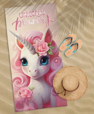 A beach scene with a unicorn towel, flip-flops, and a straw hat.